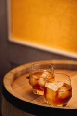 Glass of whiskey on wooden background close up