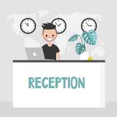 Young smiling concierge standing behind the reception desk