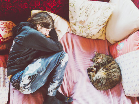 Handsome Man And Cat Sleeping On The Sofa