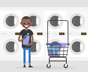 Daily routine. Young character washing clothes in a public coin laundry. Flat editable vector illustration, clip art