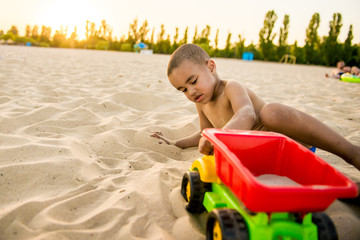 little black boy playing on beach summer