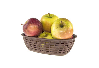wet apples in a basket on a white background