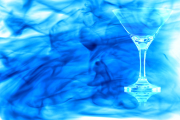 Empty the cocktail glass enveloped in blue smoke.