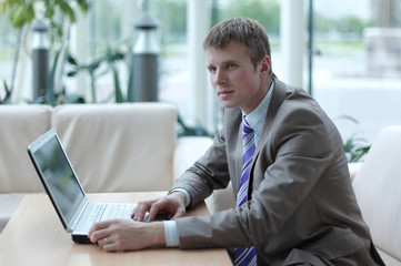 Young employee looking at computer monitor during working day