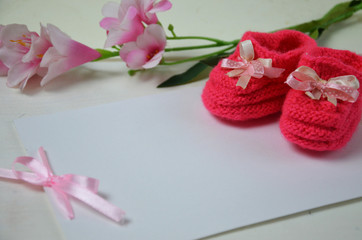 Baby girl knitted sandal, booties, shoes baby newborn, blank postcard. cocept it s a girl or baby shouer