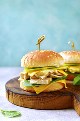 Healthy homemade cheeseburger with boiled chicken, apple and spinach.
