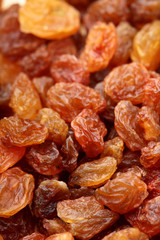 Brown raisin pile. Selective focus. Closeup photo image of brown raisin in a pile present a detail of texture .Texture of raisins