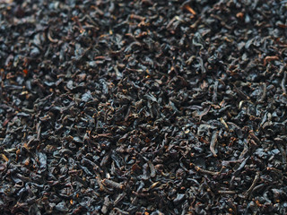 Fototapeta premium Black leaf tea background. Selective focus