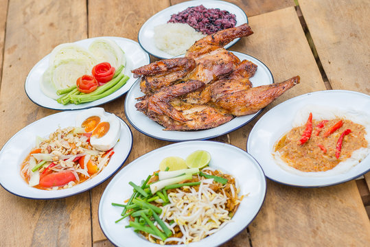 Grilled chicken, Papaya salad or Som Tum, Pad Thai, Kanom Jeen or rice vermicelli, Lap Moo or Pork spicy Thai style famous local the eastern delicious food of Thailand.