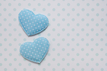 Valentine's Day. Congratulatory background...Two blue hearts on a background of polka dots.