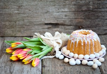 Sliced easter orthodox sweet bread, kulich with white tulips. Breakfast. 