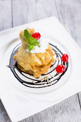 ried icecream with whipped cream and cherry on top and chocolate dressing