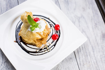 ried icecream with whipped cream and cherry on top and chocolate dressing