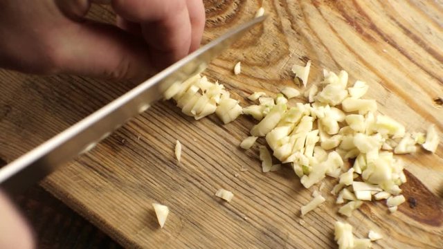 Finely chopped garlic on a board. Video