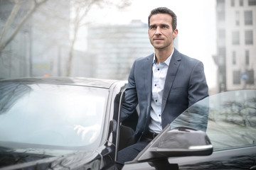 Handsome man sitting in his car