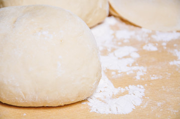 Fototapeta na wymiar Raw wheat yeast dough on the table