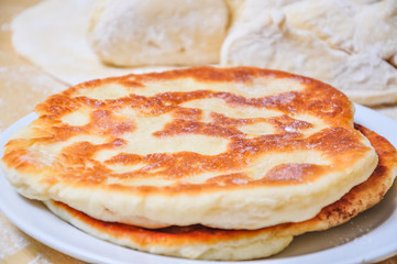 Ready fried wheat pitas and raw yeast dough