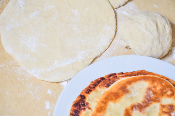 Ready fried wheat pitas and raw yeast dough