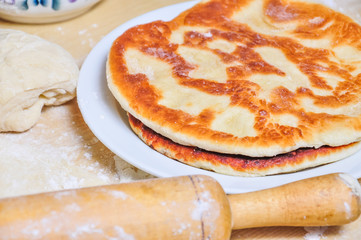 Ready fried wheat pitas and raw yeast dough