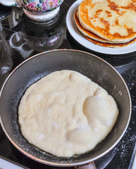 Cooking scones in a pan on the stove