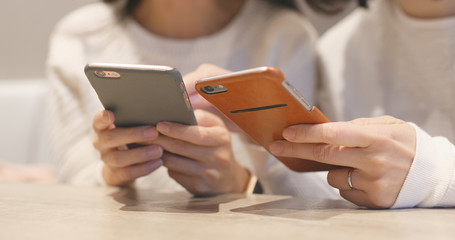 Girl friends using cellphone together