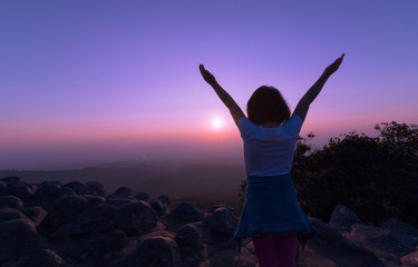 Happy child on mountain on sunset background.