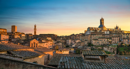 Siena sunset panoramic skyline. Mangia tower and cathedral duomo. Tuscany,