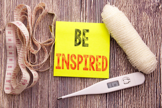 Be Inspired. Business fitness health concept for Inspiration and Motivation written sticky note empty paper background with copy space bandage and thermometer