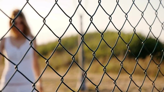 Blurred Sad and lonely woman behind a net - slow motion