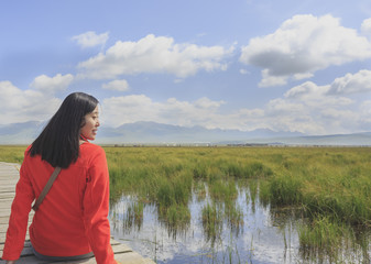 Plateau wetland scenery and a traveler in red
