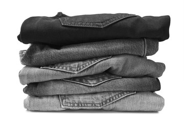 Stack of black jeans isolated on white