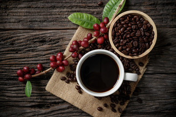 Top view mockup a cup of coffee and coffee beans in the bowl on the wooden desk.