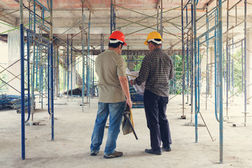 Construction concept of Engineer and Architect working at Construction Site with blue print