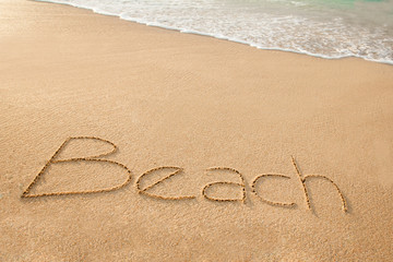 Fototapeta na wymiar word beach written on sand beach