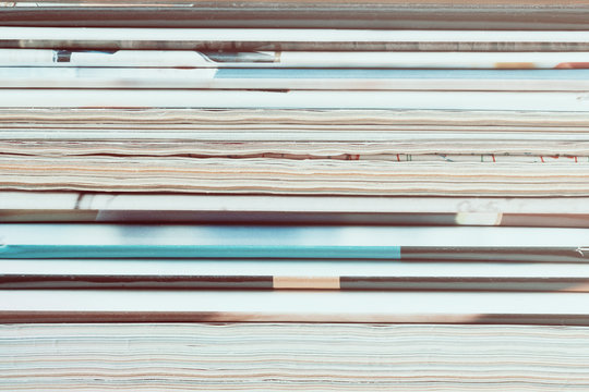 A stack of old magazines. Closeup, toned