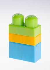 Plastic building blocks or colour blocks on a background.