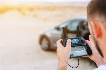 Guy controls drone with remote control