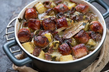 Irish coddle or sausage, bacon, onion and potato hotpot, selective focus, close-up, studio shot