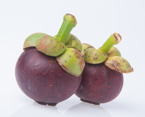 Mangosteen fruit and cross section showing the thick purple skin and white flesh of the queen of fruits.