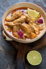 Bowl of thai massaman curry with chicken meat, selective focus, vertical shot