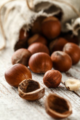 Hazelnut heap on wooden table, selective focus