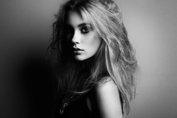 Naklejka premium Portrait of young beautiful girl with blonde hair. Fashion photo. Hairstyle. Make up. Vogue Style. Black and white photo
