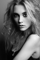 Portrait of young beautiful girl with blonde hair. Fashion photo. Hairstyle. Make up. Vogue Style. Black and white photo