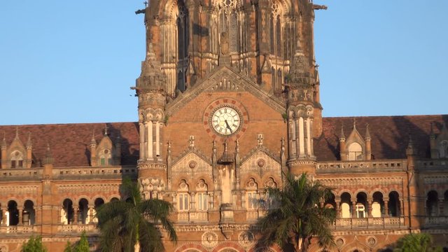 Chhatrapati Shivaji Terminus Railway Station, Zoom Out From Clock To Traffic In Mumbai, India 