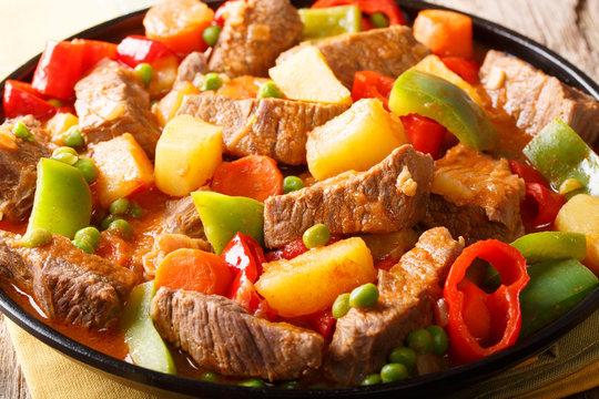 Philippine cuisine: kaldereta beef with vegetables close-up. horizontal