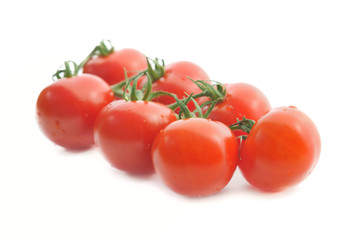 freshness group of tomatoes cevered with drops on white background