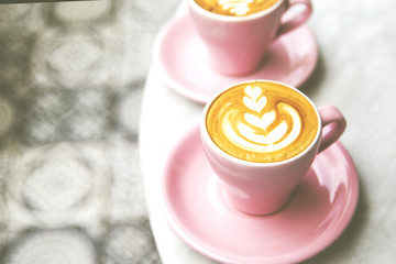 Cup of hot latte coffee on marble table background