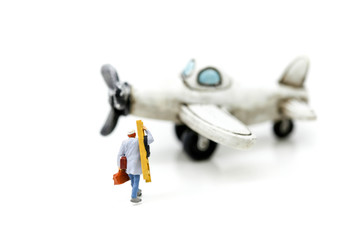 Miniature people : technician, mechanic with airplane using for background.