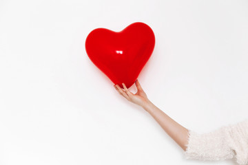 hand holding heart. happy valentine's day concept. red heart balloon on white background with space...