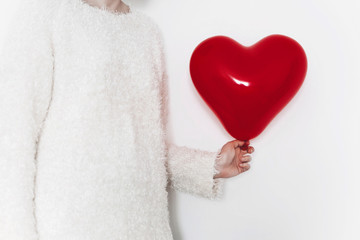 hand holding heart. happy valentine's day concept. red heart balloon on white background with space...